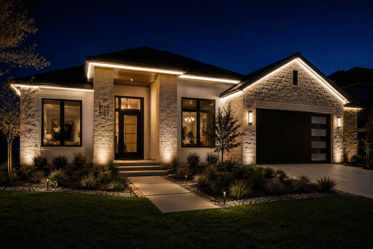 Modern white stone house at night featuring glowing LED roofline lights and illuminated landscaping.